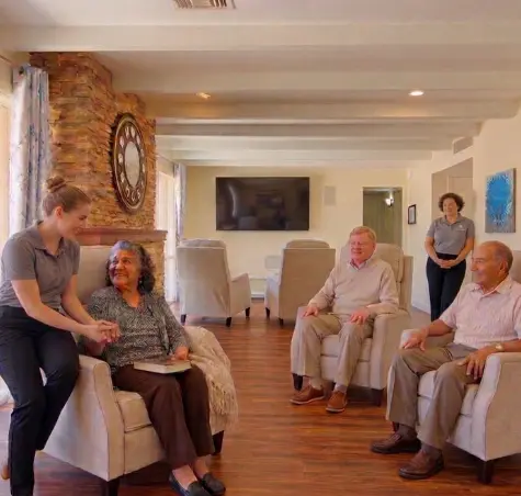 Attentive staff supporting residents at The Gardens